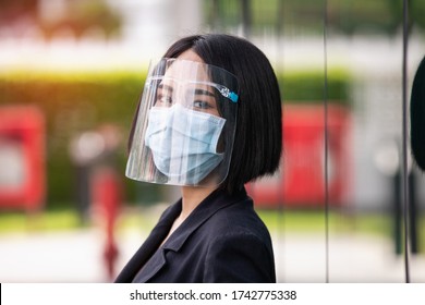 Asian Young Business Woman Wearing Face Shield And Mask For Healthcare Which Is Required For Doctor And General Public To Prevent COVID-19.