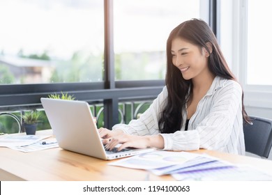 Asian young business women work from home new project modern loft,laptop in coffee shop cafe,Analyze plans,papers,  texting keyboard.design notebook quaratine coronavirus,technology startup business  
