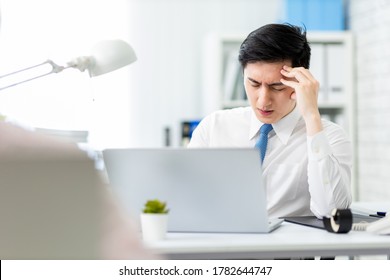 Asian Young Businessman Has Headache And Feel Upset In Office