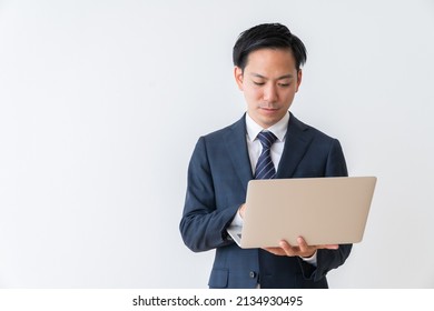 Asian Young Businessman Using Laptop