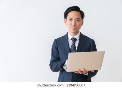 Asian Young Businessman Using Laptop