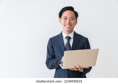 Asian Young Businessman Using Laptop