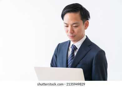 Asian Young Businessman Using Laptop