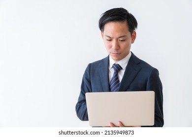 Asian Young Businessman Using Laptop