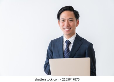 Asian Young Businessman Using Laptop