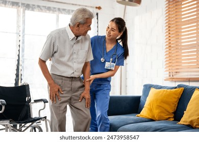 Asian young caregiver take care senior man on wheelchair in house. Attractive nurse doctor support elderly older mature male patient sitting on sofa at nursing home care. Medical insurance concept. - Powered by Shutterstock