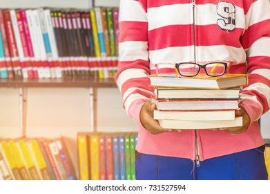 Asian Young College Student Teenager Smile With School Folders Reading Book At Library High School University Campus College Knowledge Center For Study Learning And Bright Idea In Summer Holiday.