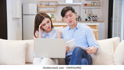 Asian Young Couple Calculate Expenses Finance With Laptop And They Have Some Argument At Home