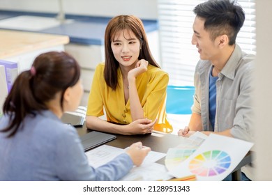 Asian Young Couple Discuss With Female Interior Designer For Their New Home