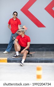 Asian Young Couple Or Friends Man And Woman Playing Surfskate Or Skate Board In Urban City Outdoor. Extream Sports 