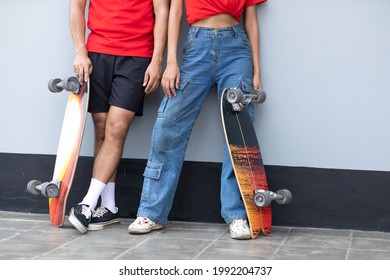 Asian young couple or friends man and woman playing surfskate or skate board in urban city outdoor. Extream sports  - Powered by Shutterstock