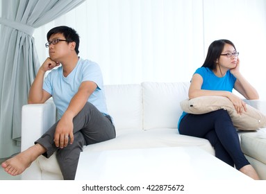 Asian young Couple having argument in the living room - Powered by Shutterstock