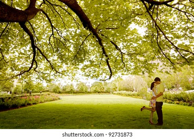 Asian Young Couple Kissing Under Tree Near St. Patrick Cathedral, Melbourne - Australia