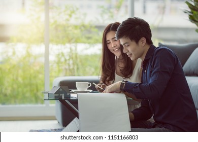 Asian Young Couple Is Planning To Build His Future House With His Wife In A Modern Apartment.