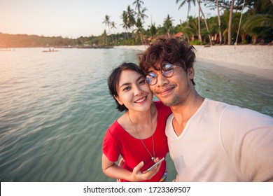 Asian Young Couple Traveller Happy In Love Smiling Take A Selfie On The Beach.