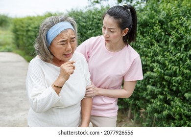 Asian Young Daughter Caring For Sick Senior Mother To Suffering Illness Or Cough At Home . Old Mom Suffering From Illness Has An Adult Caregiver Woman To Take Care