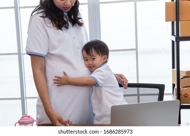 Asian Young Family Help Together Feeding Adorable Cute Girl At Home, Father Making Small Business Marketing Online Logistic Home Office, Mother Playing With Child, Parenthood Duty Multi Task Concept