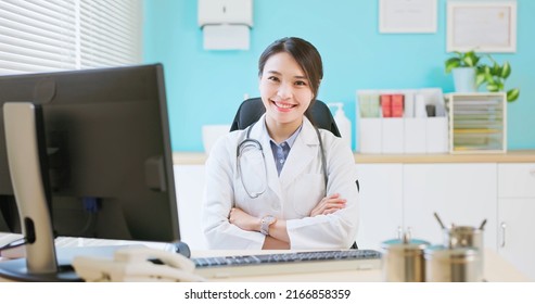 Asian Young Female Doctor Smile At You With Cross Arm In The Clinic Or Hospital