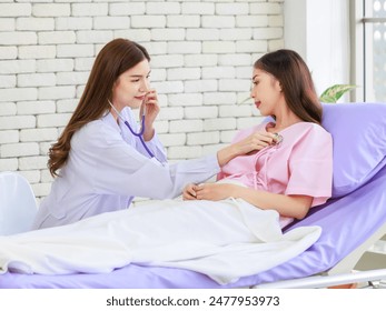 Asian young female doctor using a stethoscope listen to the heartbeat of woman patient check up , woman lying on bed in hospitall, Healthcare concept. - Powered by Shutterstock