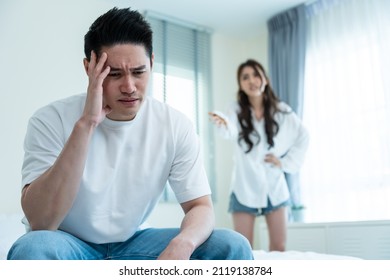 Asian Young Girl Feel Angry Boyfriend Having Conflict Domestic Problem. New Marriage Man And Woman Feel Heartbroken For Quarrel Conflict While Sit On Bed In Bedroom. Family Problem-separation Concept.