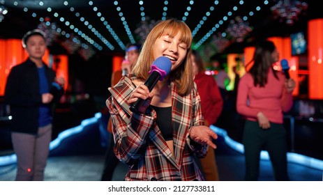 Asian Young Girl With Friends Dancing And Singing At Karaoke Club, Njoying Friendship Together In Bar, Concept Of Party, Fun, Holiday, Relaxation, Time To Sing, Having Good Time