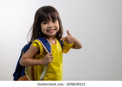  Asian Young Girl Showing Her Arm With Yellow Bandage After Got Vaccinated Or Inoculation, Child Immunization, Covid Delta Vaccine Concept