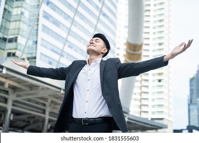 Asian Young Handsome Businessman Feeling Fresh And Relax, Breathing Fresh Air In The City. The Man Stretching And Opening Arms Feeling Happy For Working In Office For Business Job In Big Company.