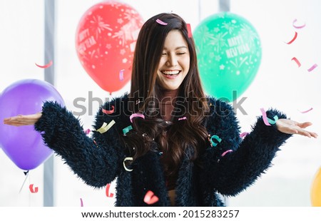 Similar – Young cheerful woman with a gift over her head