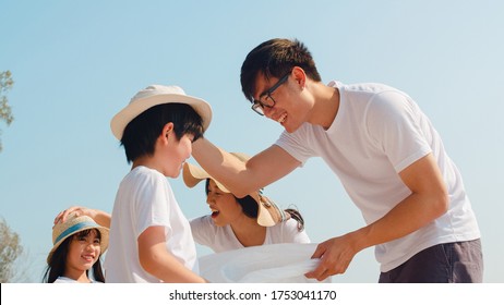 Asian young happy family activists collecting plastic waste on beach. Asia volunteers help to keep nature clean up and pick up garbage. Concept about environmental conservation pollution problems. - Powered by Shutterstock