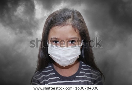 Asian young kid wearing a mask