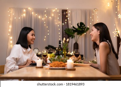 Asian Young Lesbian Couple Have A Romantic, Candlelit Dinner In Her Home.