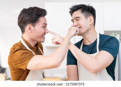 Asian Young LGBTQ Male Gay Couple Enjoy Bake Bakery In Kitchen At Home. Attractive Handsome Romantic Man Couple Wear Apron Cooking Food Feeling Happiness And Cheerful To Spend Time Together In House.