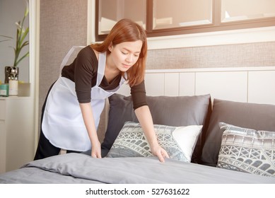 Asian Young Maid Tidying Up Bed In Hotel Room, Cleaning Service Concept