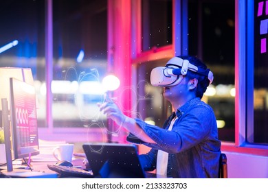 asian young male wearing wearable goggle headset virtual online meeting digital space working with 3d augmented dimension at home,cyber virtual working with virtual vr goggle and pc desktop device  - Powered by Shutterstock