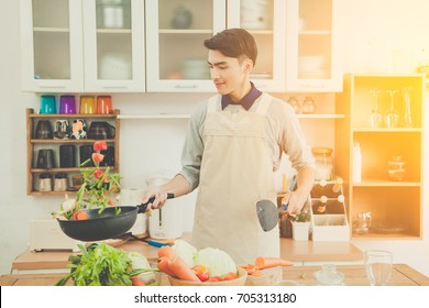 Asian young man is cooking