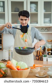 Asian Young Man Is Cooking