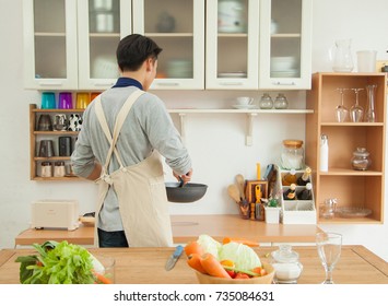 Asian Young Man Is Cooking