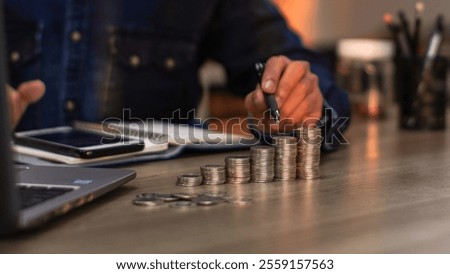 Asian young man counting stack of coins. invest save finance concept, saving money, investment