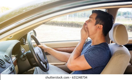 Asian Young Man Driving A Car And Feel Sleepy.