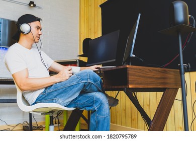 Asian Young Man Enjoy Coffee While Listening Music And Watching Video On  Social Media