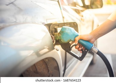 Asian young man Handing fuel nozzle refuel to truck. 