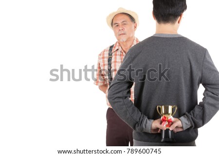Asian young man hold a trophy surprise father