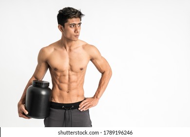 Asian Young Man With Muscular Body Carry A Black Bottle With One Hand Stand Facing Forward And Look To Side On Isolated Background