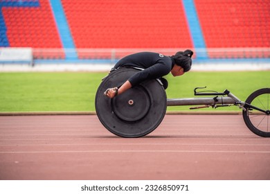 Asian young man para-athletes disabled practice handcycling in stadium. Attractive amputee male runner exercise and practicing workout for Paralympics competition regardless of physical limitations. - Powered by Shutterstock