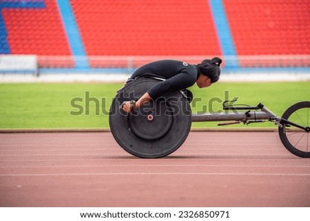 Asian young man para-athletes disabled practice handcycling in stadium. Attractive amputee male runner exercise and practicing workout for Paralympics competition regardless of physical limitations.