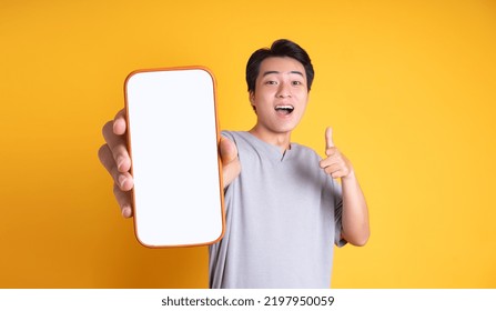 Asian young man posing on a yellow background - Shutterstock ID 2197950059