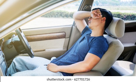 Asian Young Man Sleeping In His Car.