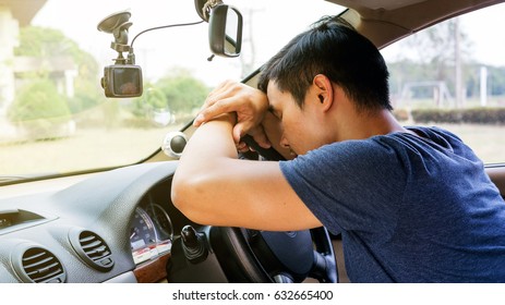 Asian Young Man Sleeping In His Car.