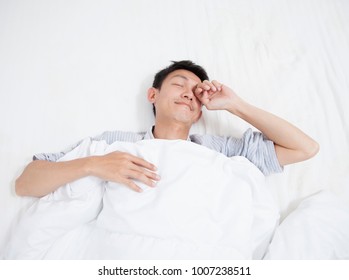 Asian Young Man Stretching While Waking Up In The Morning.
