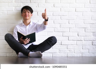 Asian Young Man Student With Books In Hands